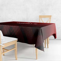 Red tablecloth draped over table with dark graphic lines and winged trophy logo