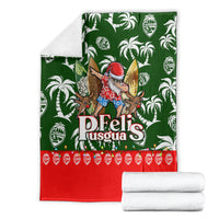 Folded green tropical Christmas blanket with Santa character, white palm prints, and red bottom