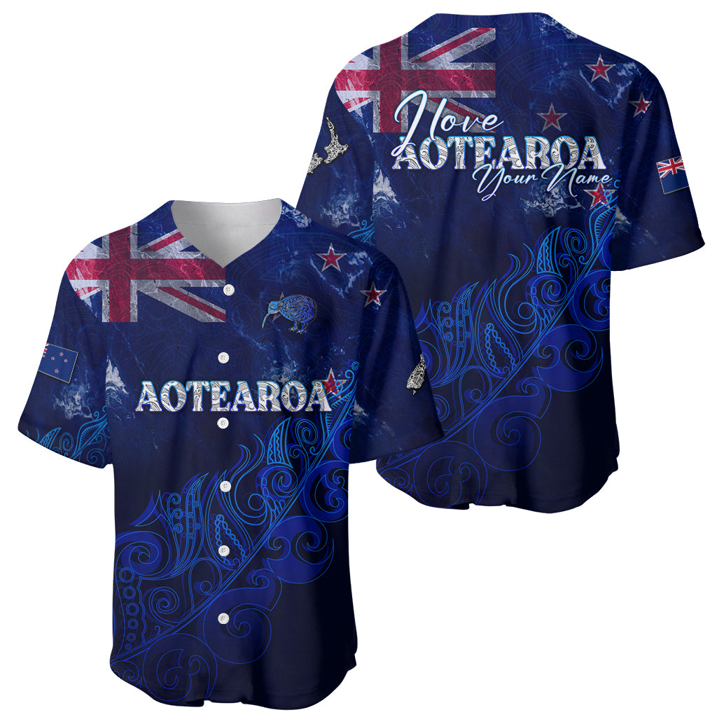Two blue baseball jerseys with Aotearoa graphics, showing front and back designs.