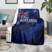 Blue personalized blanket on sofa with Aotearoa lettering and silver fern graphic