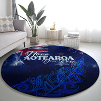 Round blue Aotearoa map rug featuring “I love AOTEAROA” and stylized fern swirls