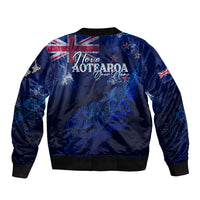 Blue bomber jacket back graphic with Aotearoa text, silver fern, stars and spirals