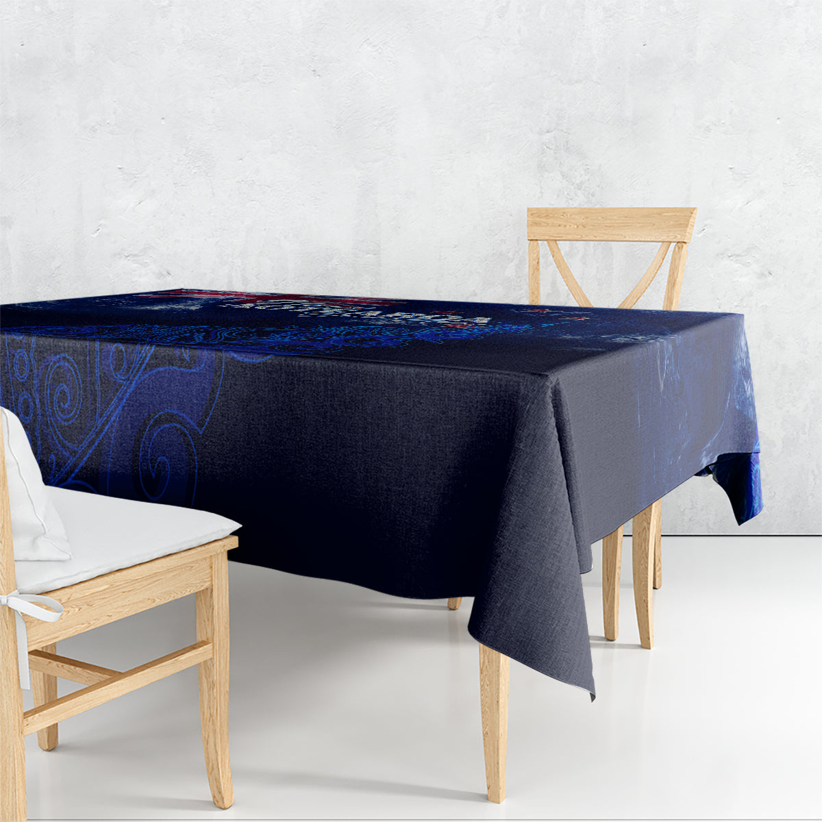 Blue tablecloth draped over rectangular table with Aotearoa map motif