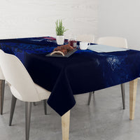 Blue tablecloth on dining table with Aotearoa map and swirling fern design