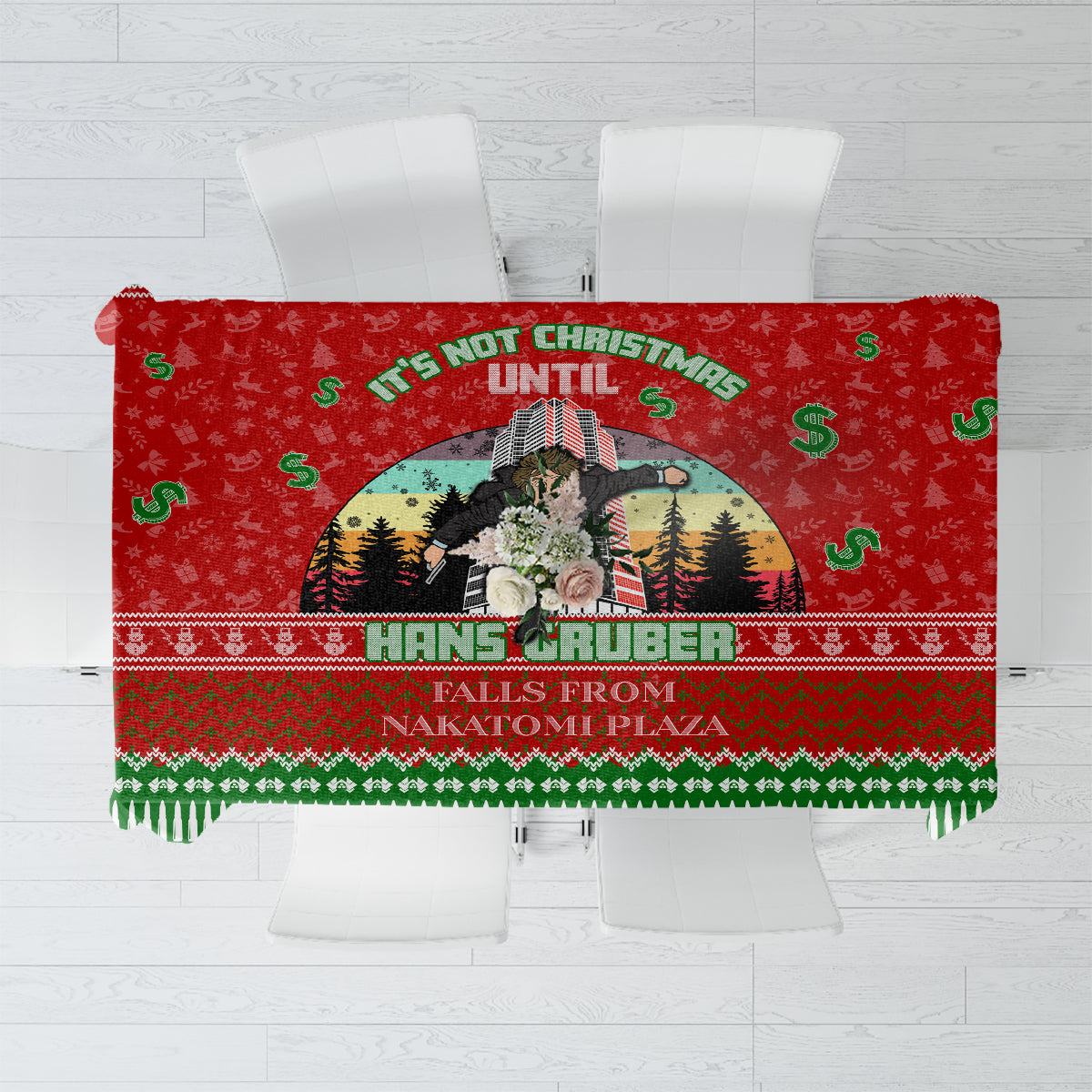 Red and green holiday graphic tablecloth with centered character scene and fringe edge.