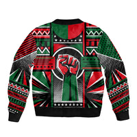 Black zip-up bomber jacket with large central crest print and multicolor African pattern, ribbed hem
