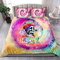 Tie-dye duvet and two pillowcases with rainbow skull face and 'We Are All Human' text