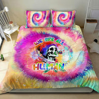 Tie-dye duvet set with two pillowcases featuring rainbow skull portrait and bold 'Human' text