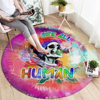 Round tie-dye carpet with “WE ARE ALL HUMAN” panda design, wide view