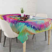LGBT tie-dye tablecloth with rainbow drip print and skull artwork, draped over dining table
