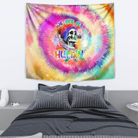 Rainbow tie-dye wall tapestry featuring a skull portrait and “WE ARE ALL HUMAN” text