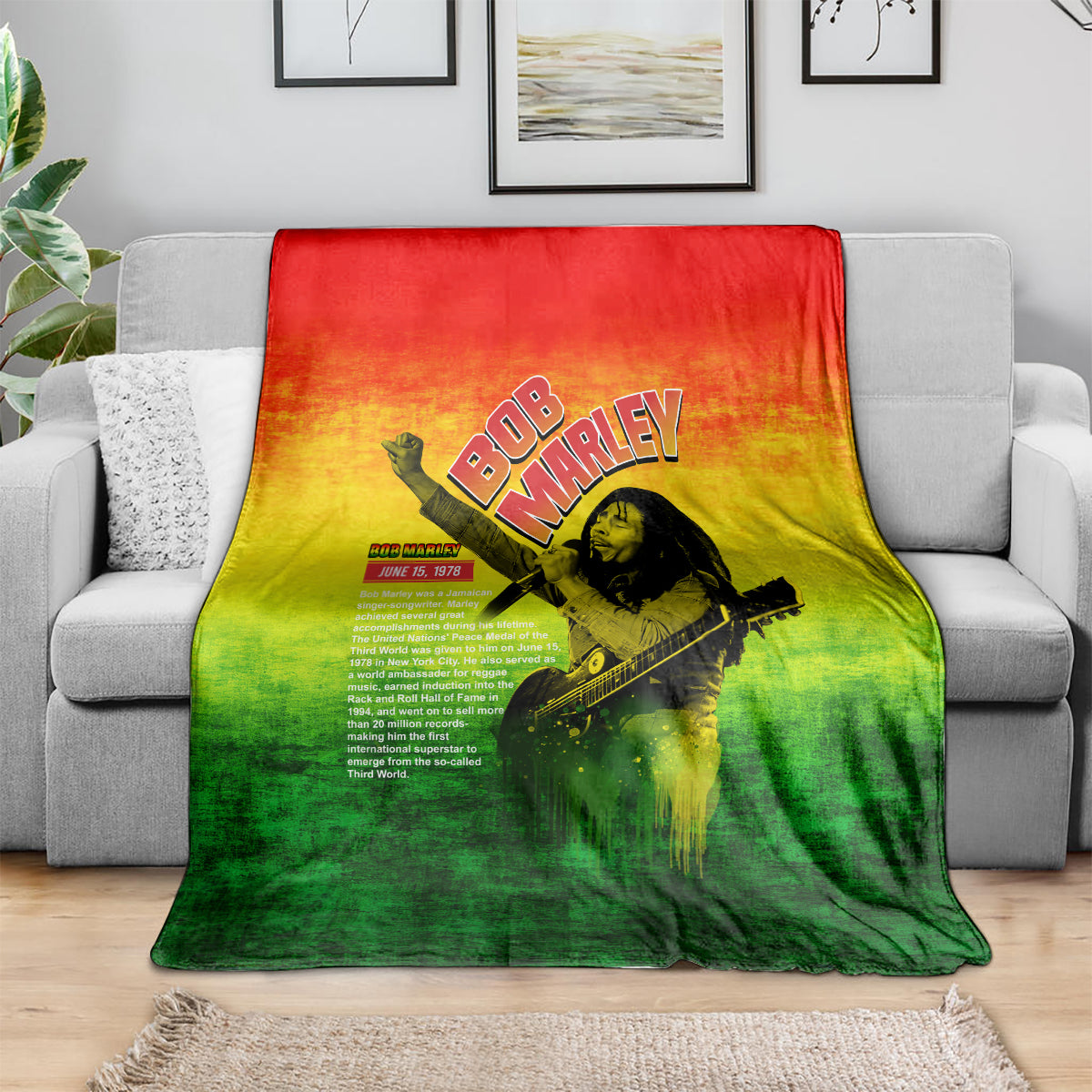 Bob Marley graphic blanket on sofa, red-yellow-green gradient with guitar portrait