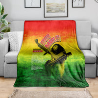 Bob Marley graphic blanket on sofa, red-yellow-green gradient with guitar portrait