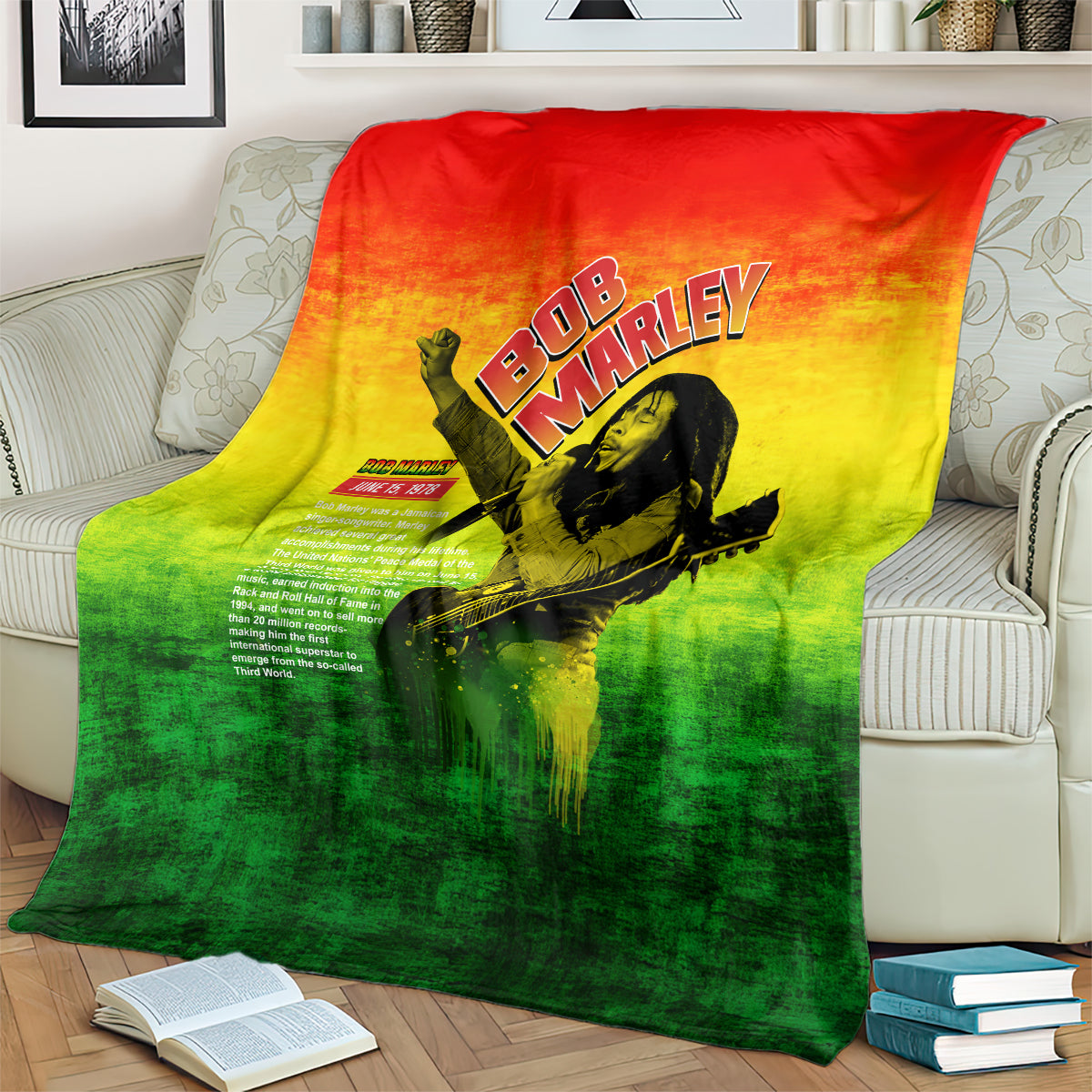 Bob Marley graphic blanket spread on couch, red-yellow-green gradient with guitar portrait