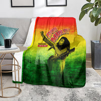 Bob Marley graphic blanket on floor, red-yellow-green gradient with guitar portrait