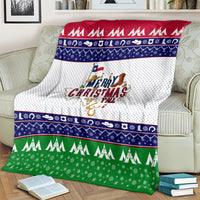 Festive Christmas throw blanket with bold red top stripe, navy patterns, and green bottom trees
