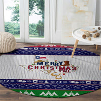 Round Christmas rug with 'Merry Christmas y'all' text, blue border with icons and green tree trim