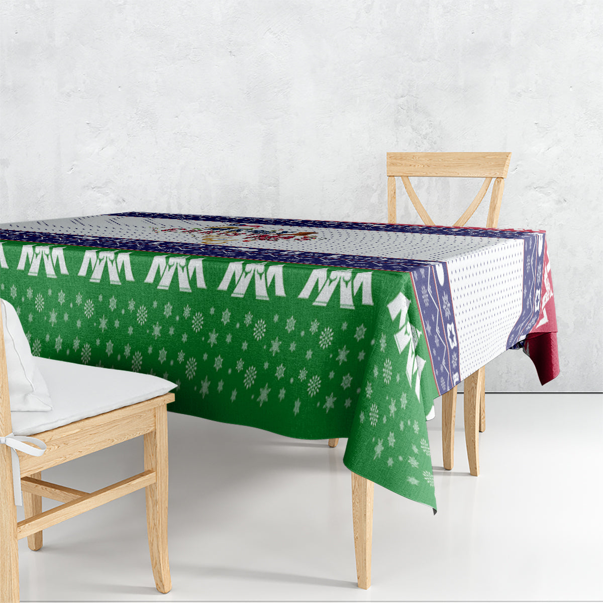 Christmas tablecloth with green snowflake main panel and navy striped edge with stars