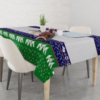 Rectangular Christmas tablecloth with green snowflakes, navy border, and white dotted center