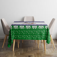 Green Christmas tablecloth with navy decorative stripe and white dotted border across top