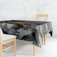 Black camouflage tablecloth draped over table with printed patriotic graphic across top