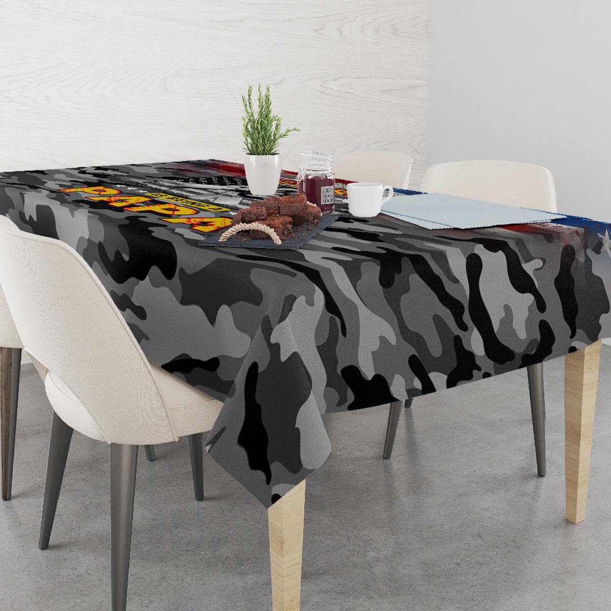 Black camouflage tablecloth with patriotic veteran artwork on tabletop, corner view