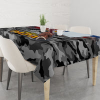 Black camouflage tablecloth with patriotic veteran artwork on tabletop, corner view