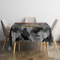 Black camouflage tablecloth covering table, patriotic graphic banner centered