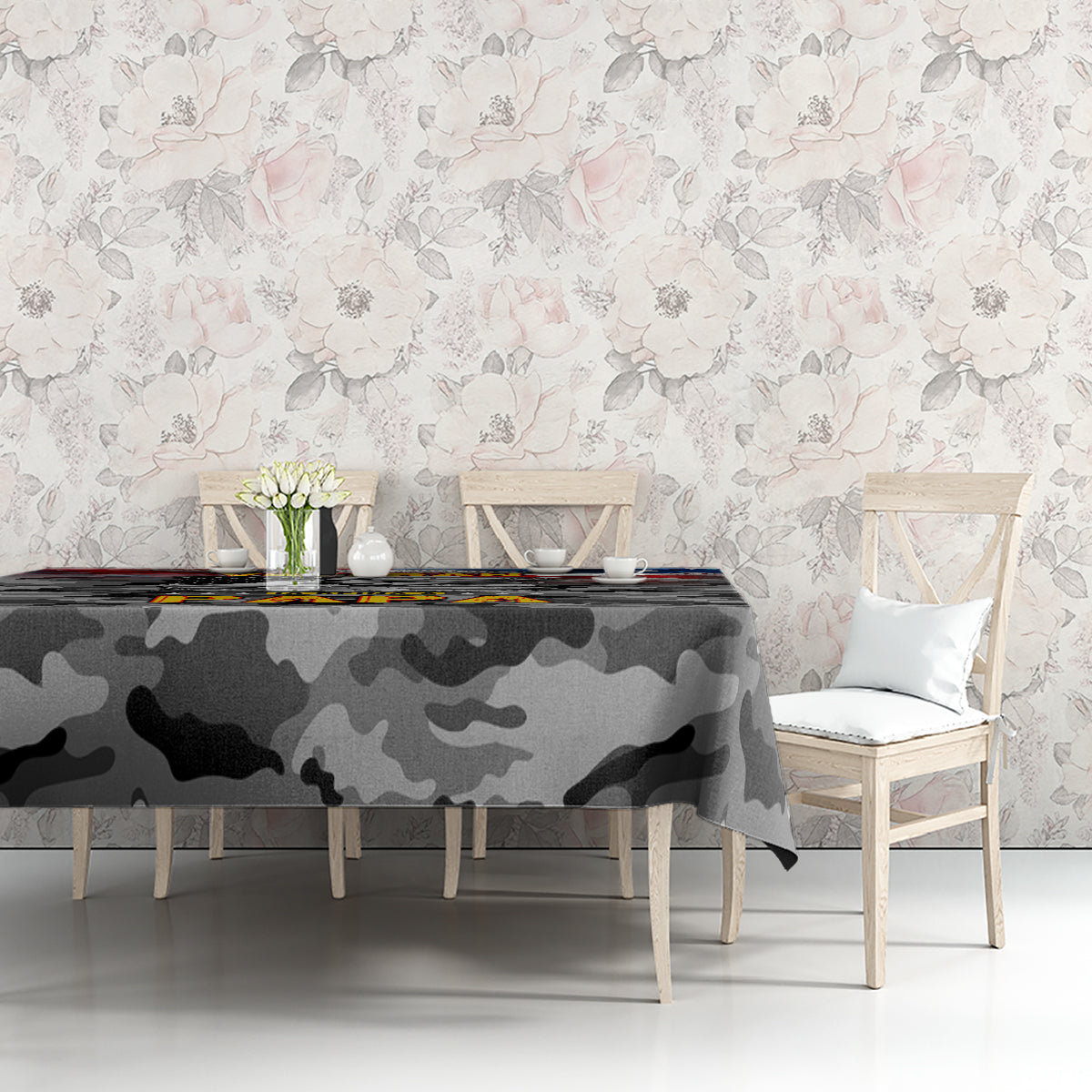 Black camouflage tablecloth on table against floral wall, patriotic graphic visible