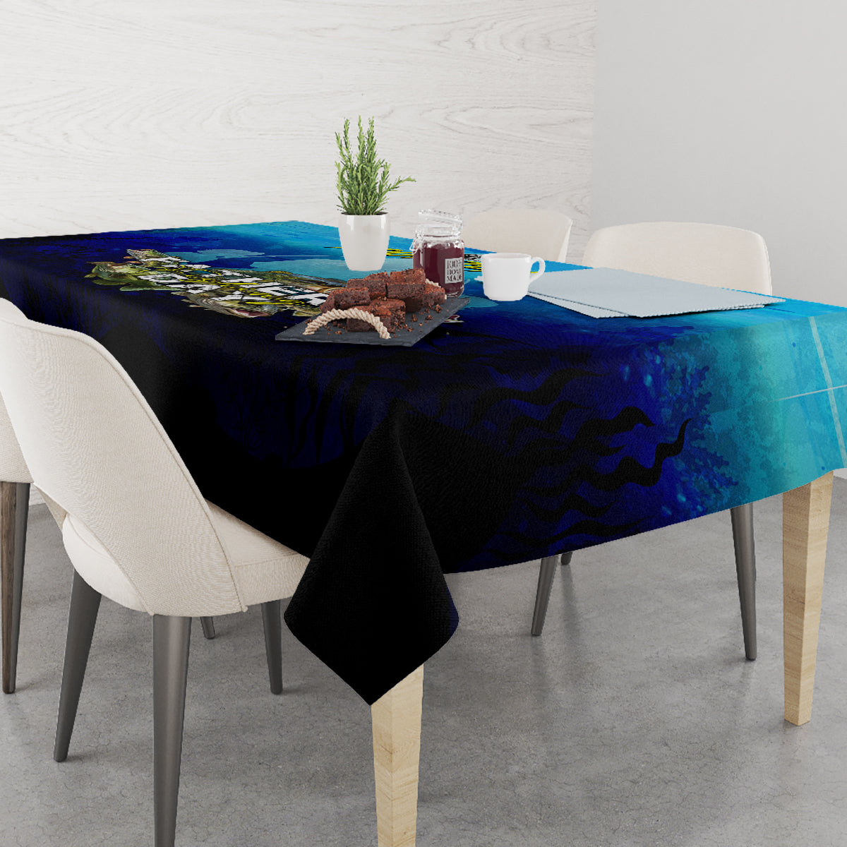Blue tablecloth with fish and water pattern covering dining table