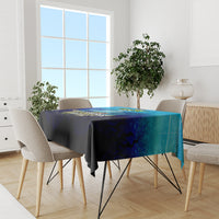 Blue fishing tablecloth on dining table with four chairs in a bright room