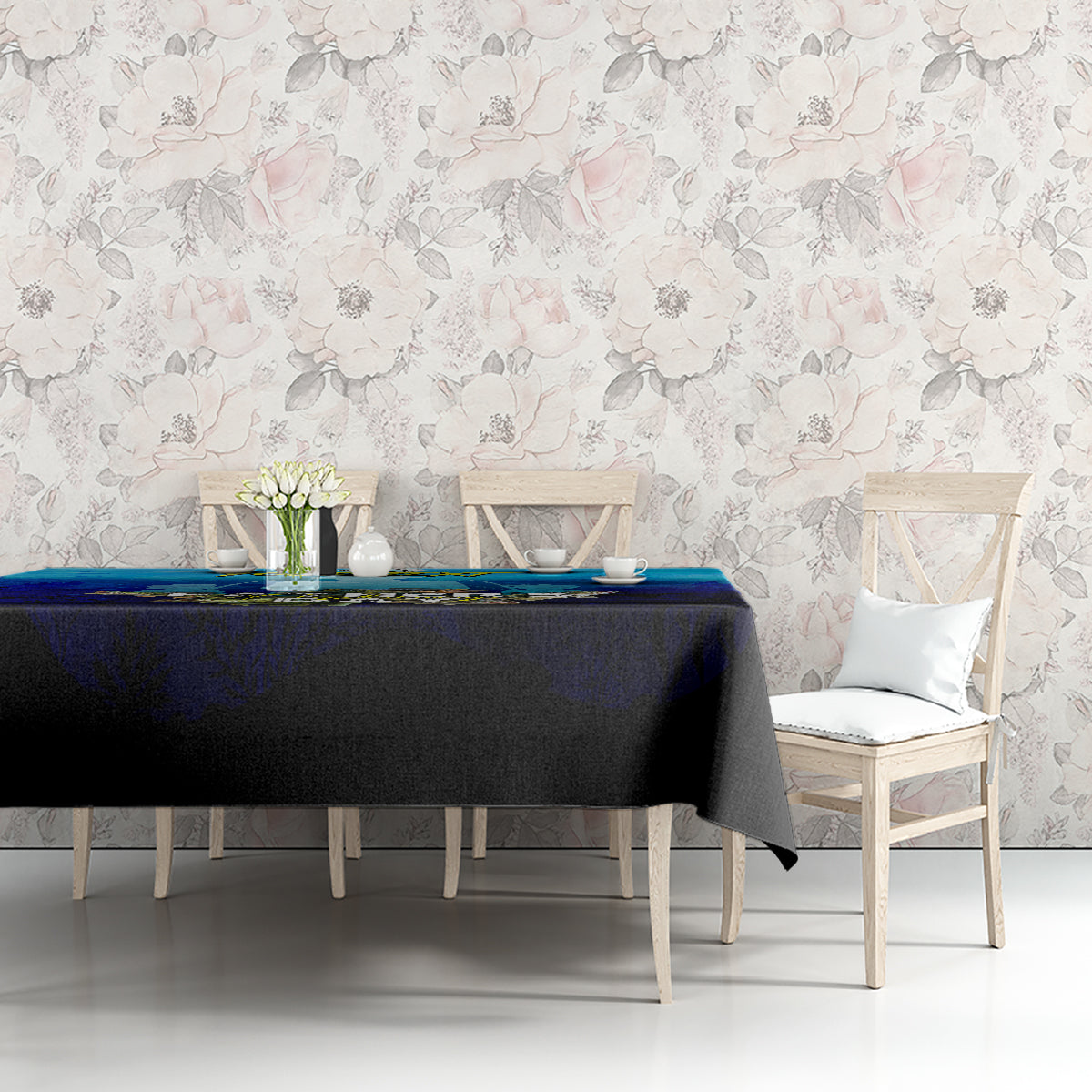 Blue dining tablecloth with fish design draped over tabletop