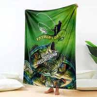 Green bass fishing Father's Day blanket draped on floor, fisherman silhouette and bass artwork