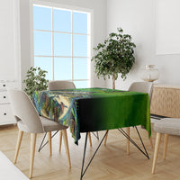 Green bass fishing tablecloth draped over a dining table with fish-themed design