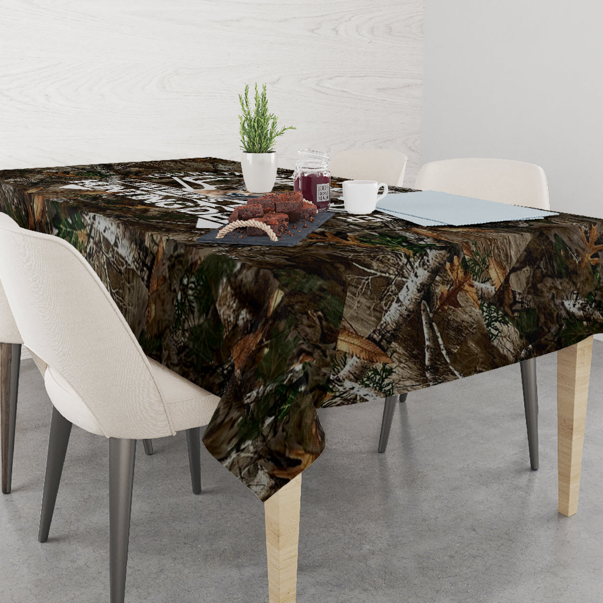 Camouflage woodland tablecloth on a dining table with chairs and place settings