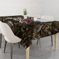 Camouflage woodland tablecloth on a dining table with chairs and place settings