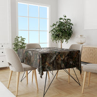 Camouflage woodland tablecloth on a rectangular dining table with four beige chairs