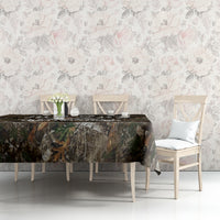 Camouflage woodland tablecloth on a dining table with white chairs and decor