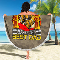 Round firefighter beach blanket with “Makes the Best Dad” graphic and fringe trim