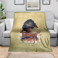 Beige personalized throw blanket on gray sofa with African woman portrait and cross artwork