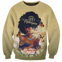 Beige crewneck sweatshirt with front graphic of woman holding cross, butterflies and flowers