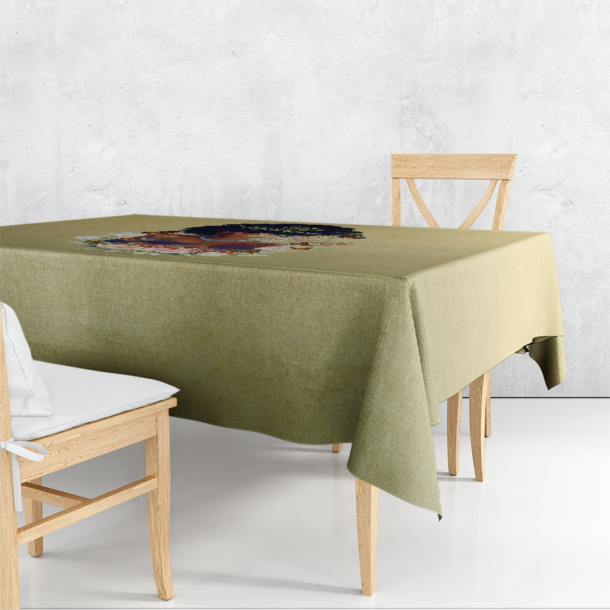 Beige tablecloth draped over dining table with printed centerpiece panel