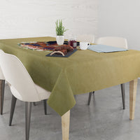 Beige tablecloth on dining table with colorful centerpiece graphic at center