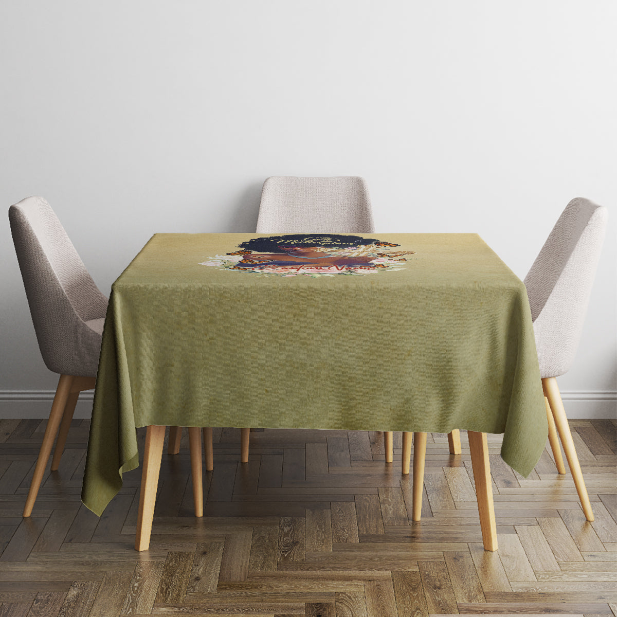 Beige tablecloth on square dining table with centered floral religious print