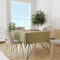 Beige personalized tablecloth on dining set with centered colorful religious graphic
