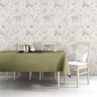 Beige tablecloth over dining table with centered floral religious text print