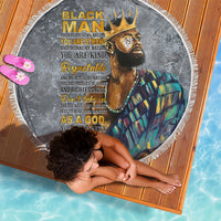 Round black beach blanket with printed portrait and gold lettering, white fringe border