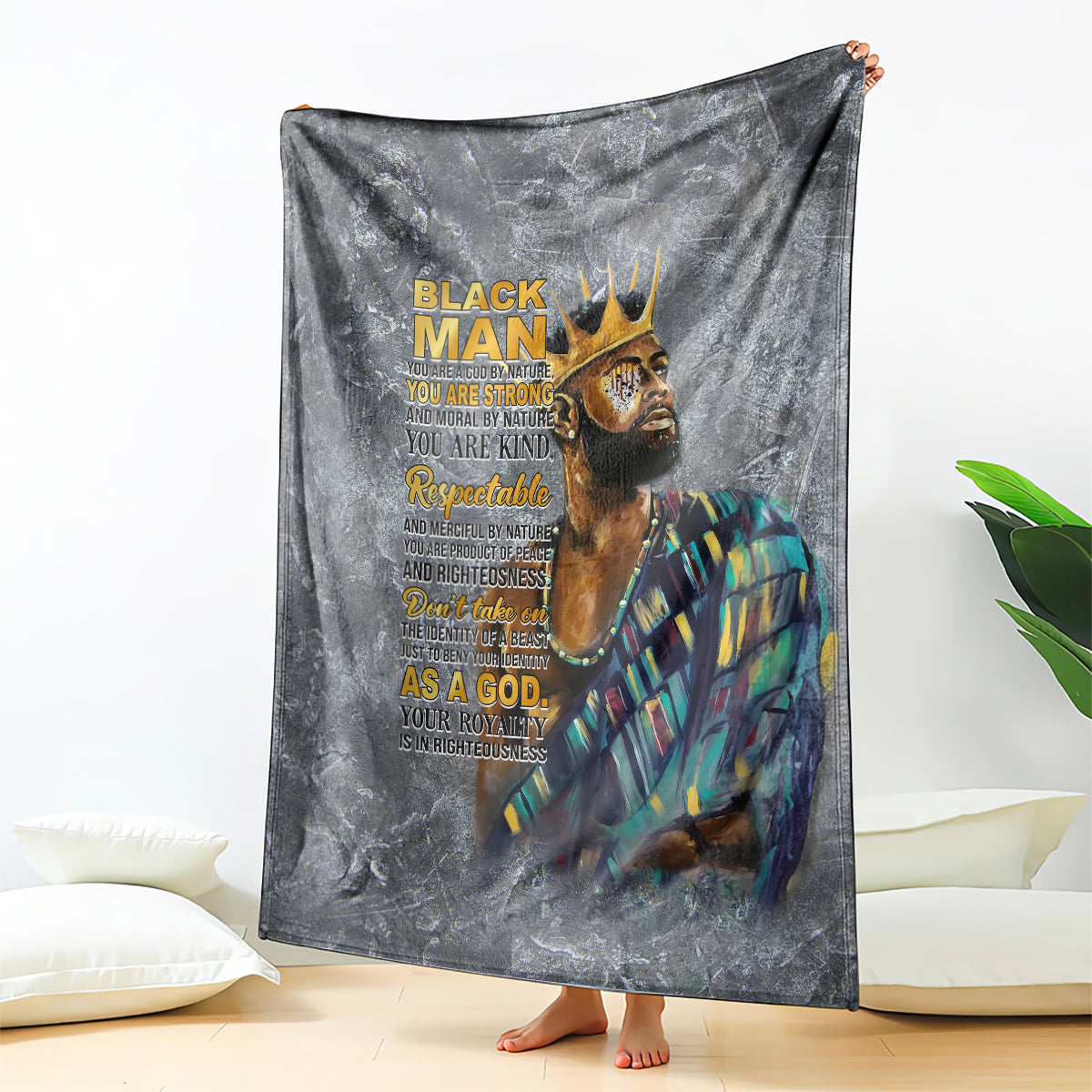 Dark gray throw blanket featuring crowned face graphic with large stacked text
