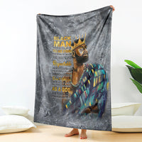 Dark gray throw blanket featuring crowned face graphic with large stacked text