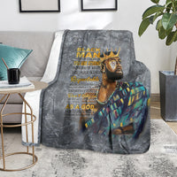 Dark gray throw blanket on chair with crowned face graphic and teal-gold robe art